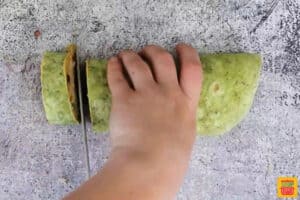 slicing jalapeno popper sandwiches with a knife