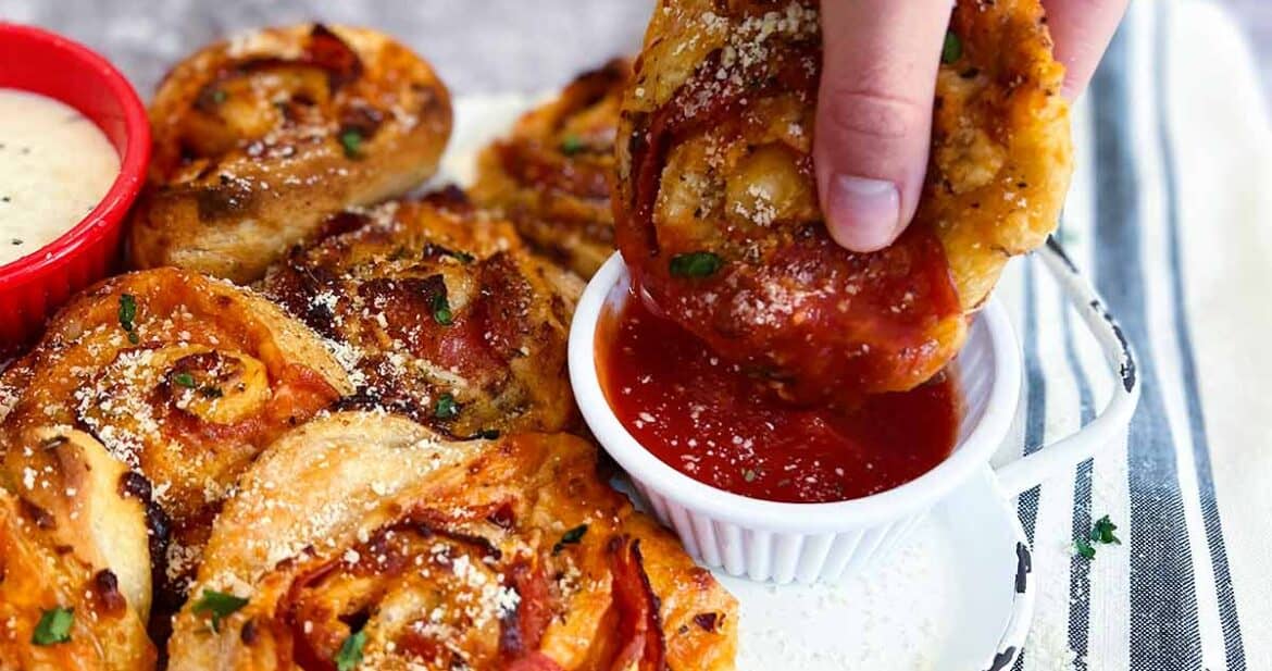 dipping a pizza roll in marinara sauce