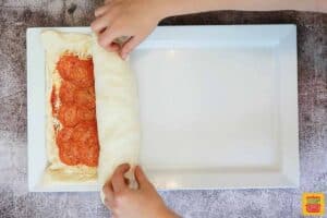 rolling pizza roll filling in pizza dough