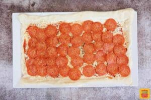 pizza dough layered with pepperoni, cheese, sauce, and other fillings