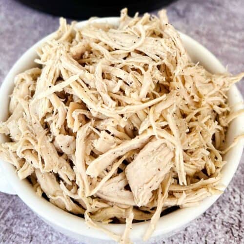 shredded chicken up close in white bowl