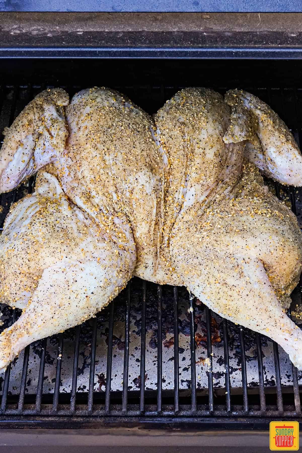 seasoned spatchcock turkey in the smoker