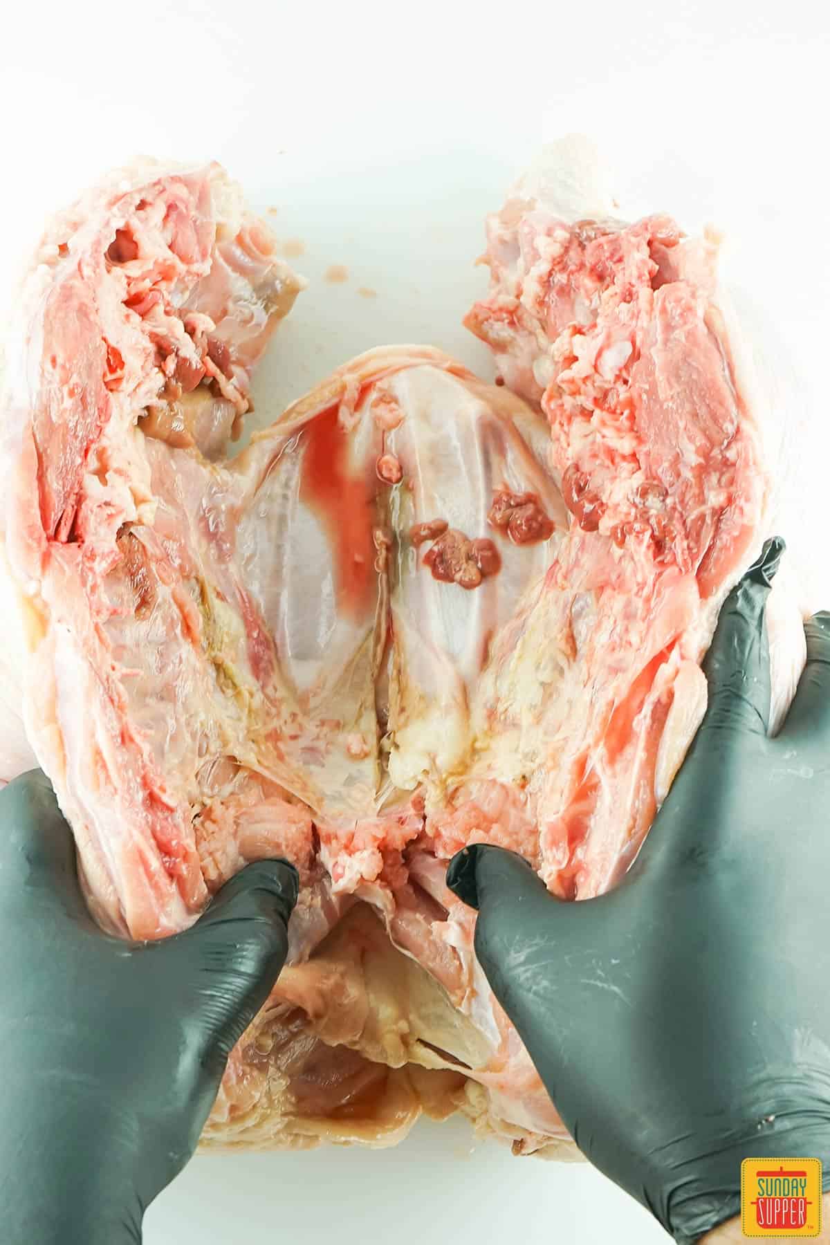 separating the breastbone from the turkey by gently pressing down