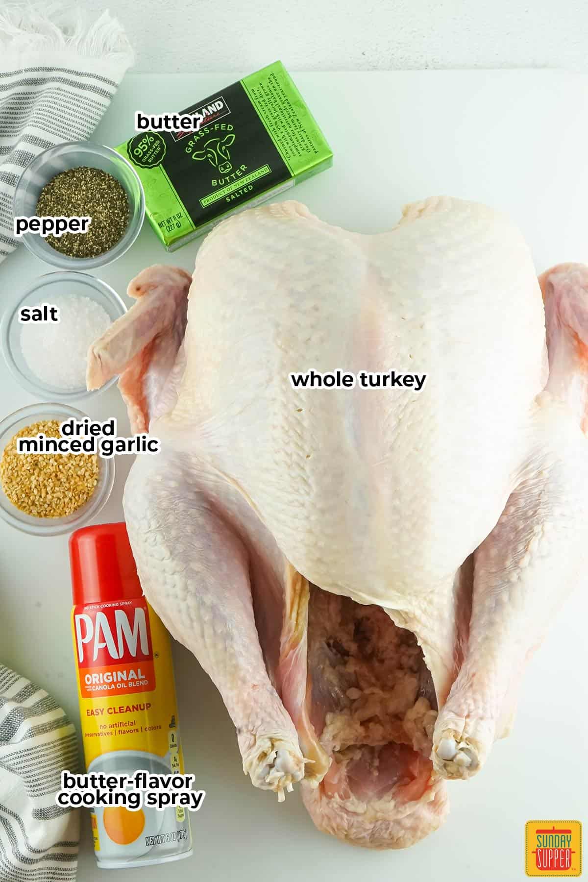 ingredients for spatchcock turkey with labels on a white surface
