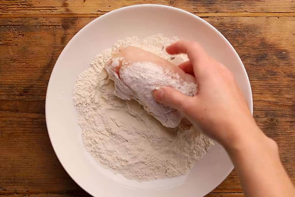 dredging chicken cordon bleu in flour
