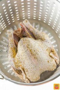 uncooked turkey placed in the fryer basket