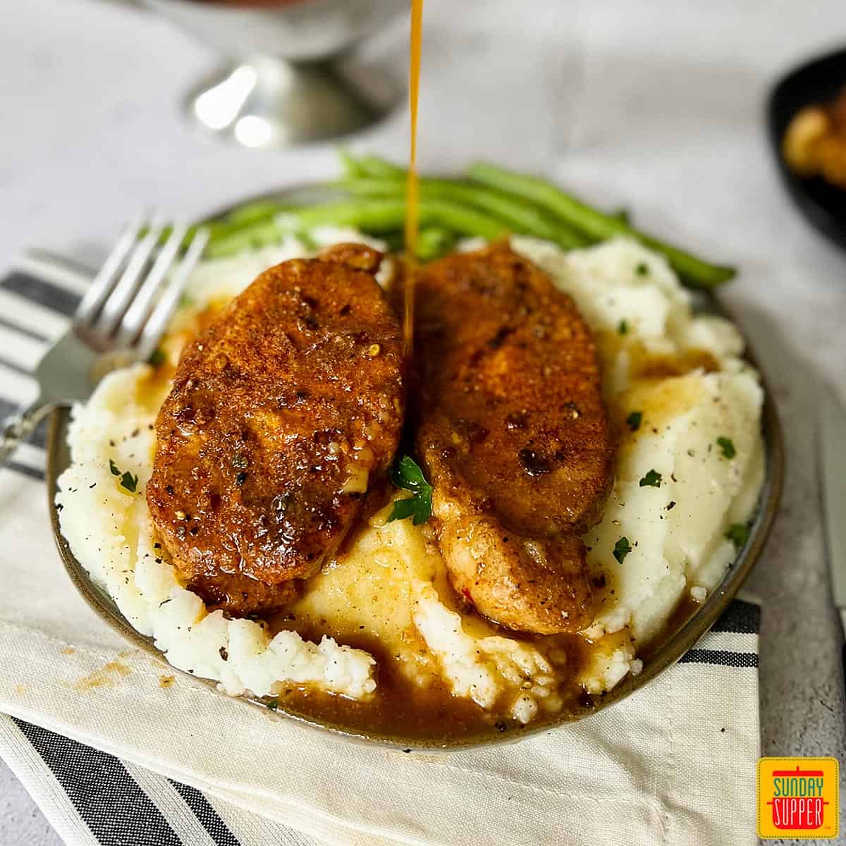 instant pot pork chops on a plate with gravy over top