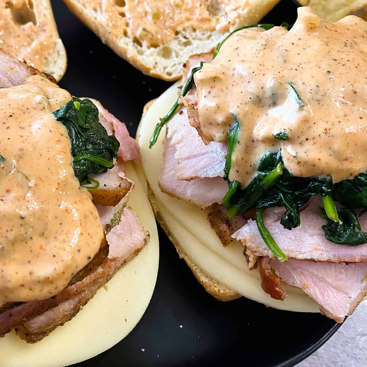 two philly pork sandwiches up close with remoulade sauce