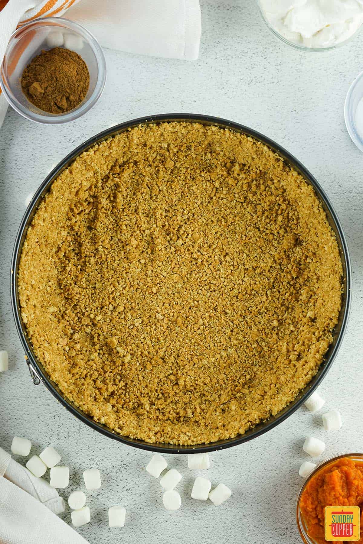 graham cracker crust placed in springform pan