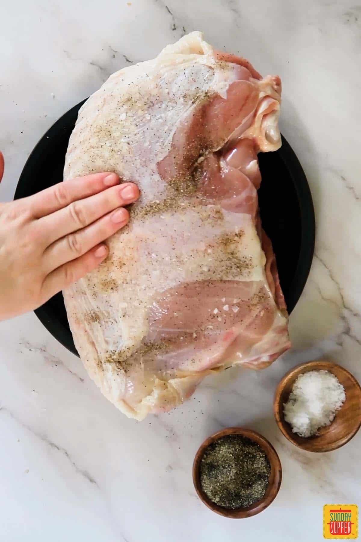 patting turkey with seasoning
