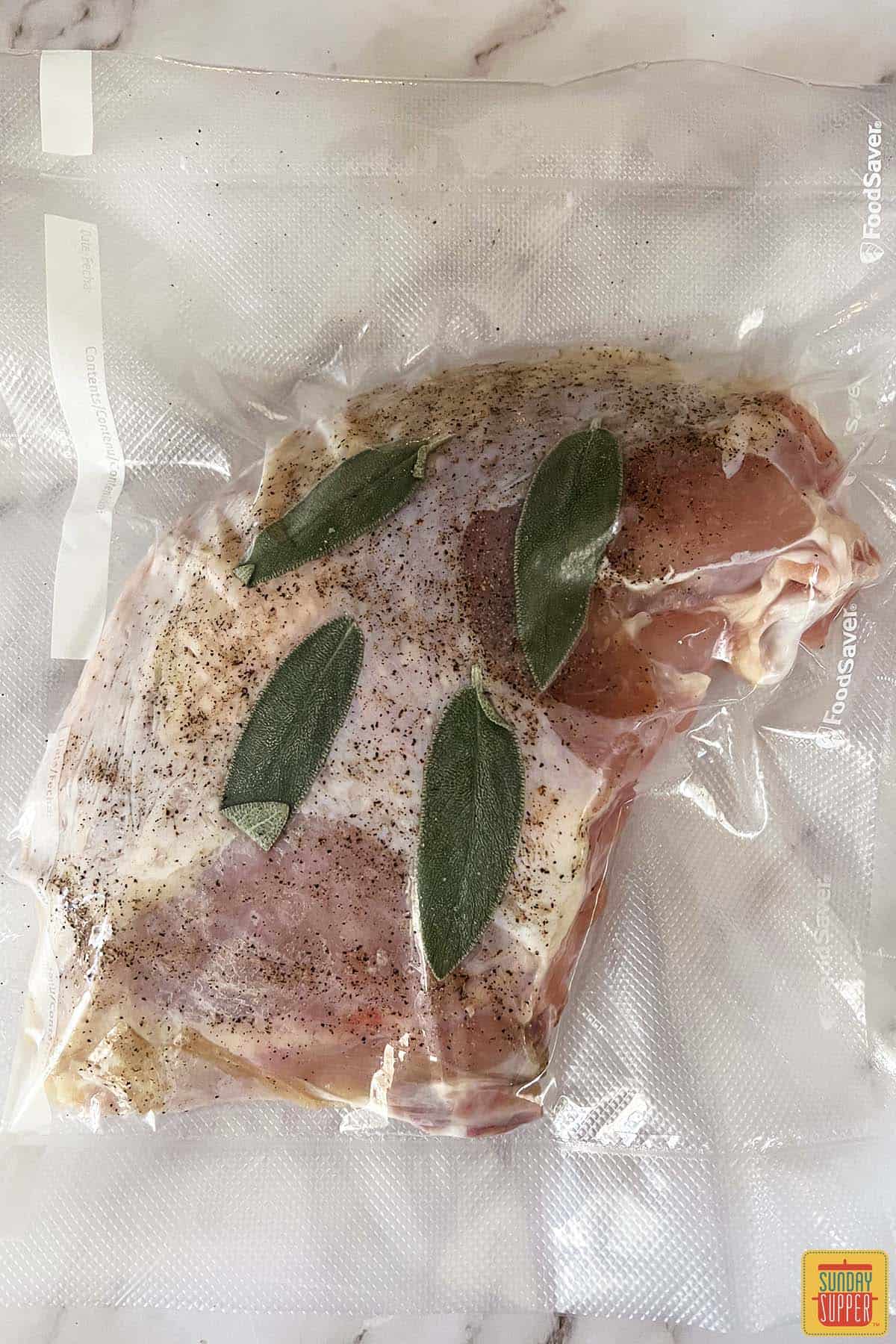 turkey breast in a vacuum sealed bag with seasoning and herbs