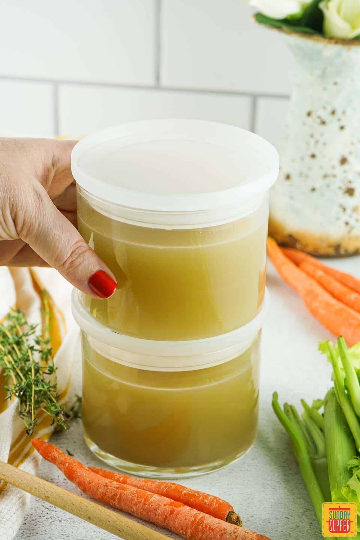 two containers of turkey stock stacked on top of each other