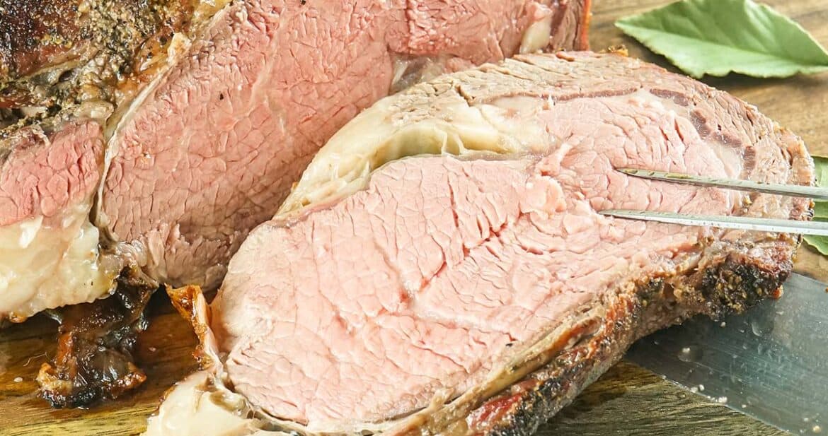 slice of prime rib on a meat fork and knife