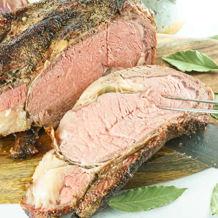 slice of prime rib on a meat fork and knife