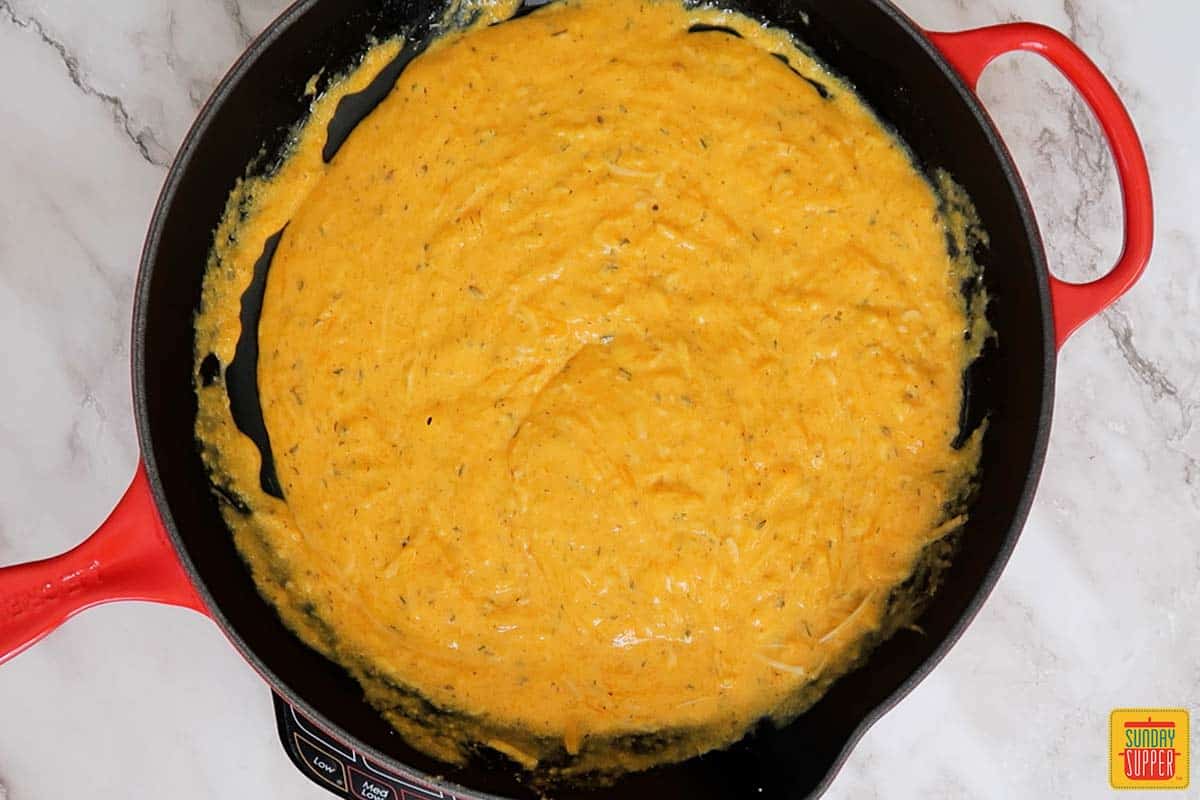 mixed butternut squash mac and cheese sauce in skillet