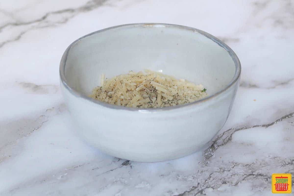 mixing the parmesan breadcrumb topping in a bowl