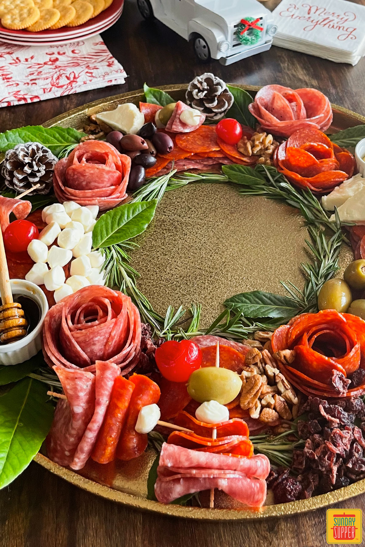 holiday charcuterie board with meats, cheeses, and olives, in the shape of a wreath