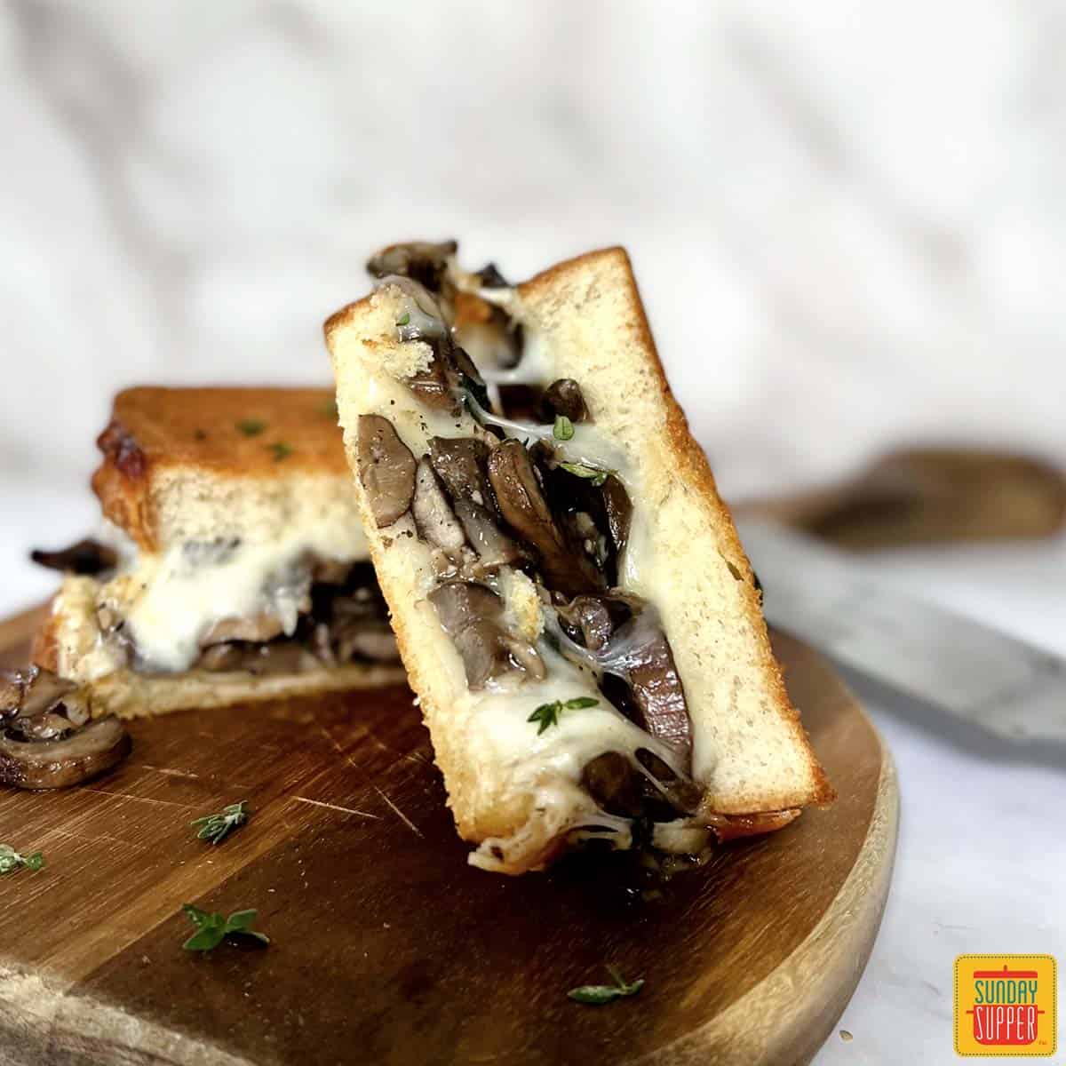 mushroom grilled cheeses on a cutting board