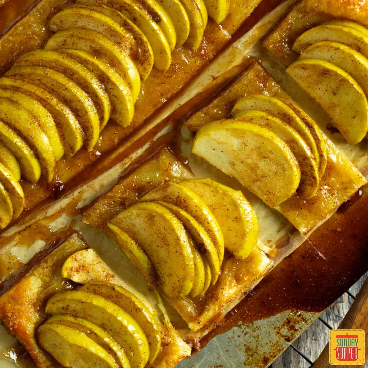 baked and sliced puff pastries on a baking sheet
