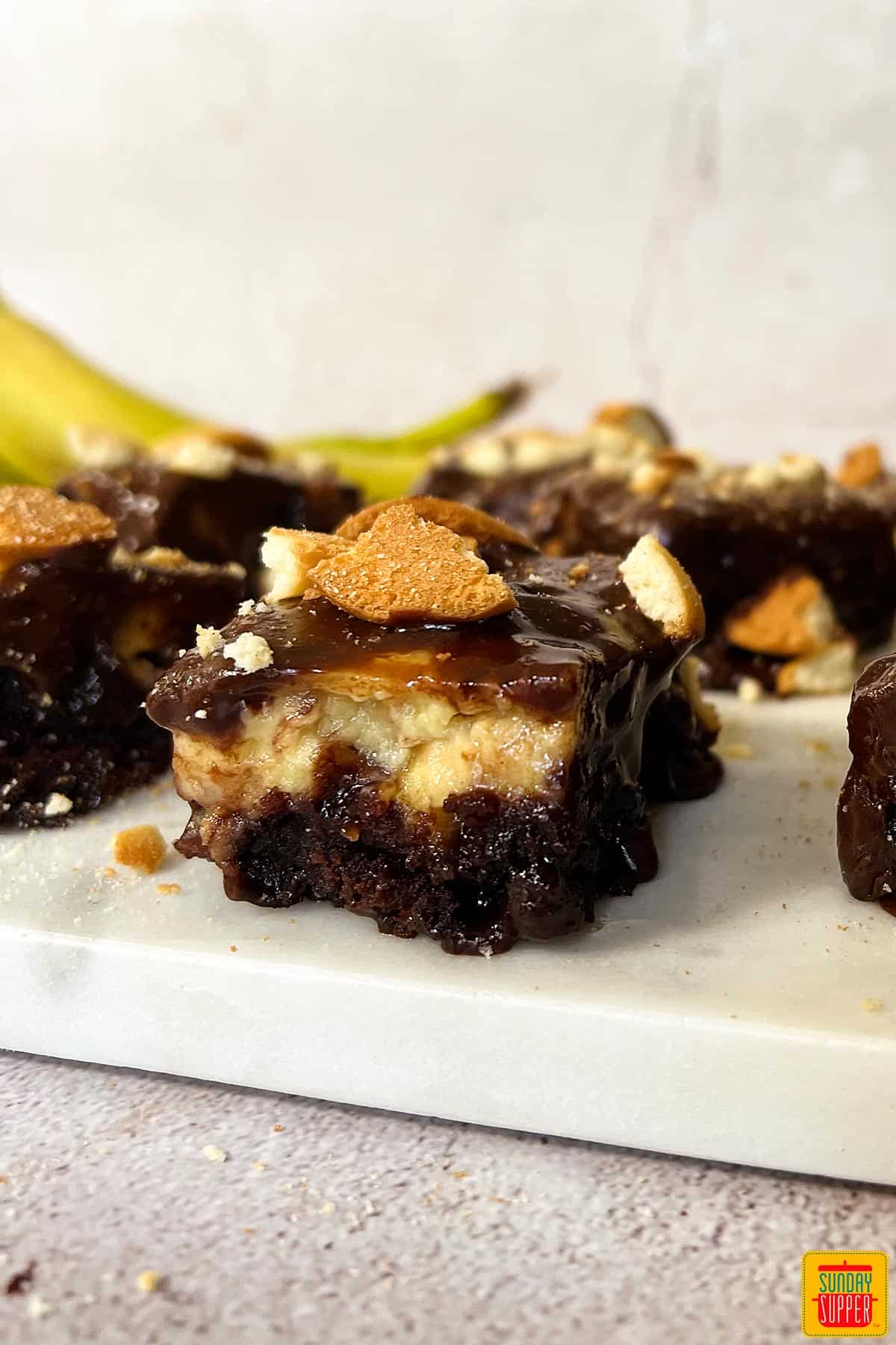 sliced banana pudding brownies on a white cutting board