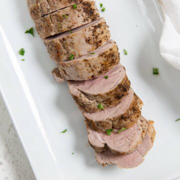 sliced instant pot pork tenderloin on a white platter