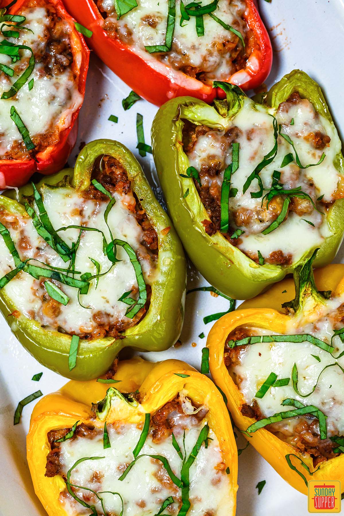 six stuffed bell peppers up close on a plate