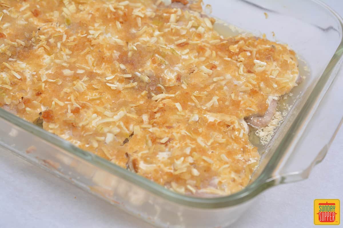oven baked French onion pork chops in a clear baking dish
