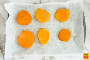 smashed sweet potatoes lined on a baking sheet