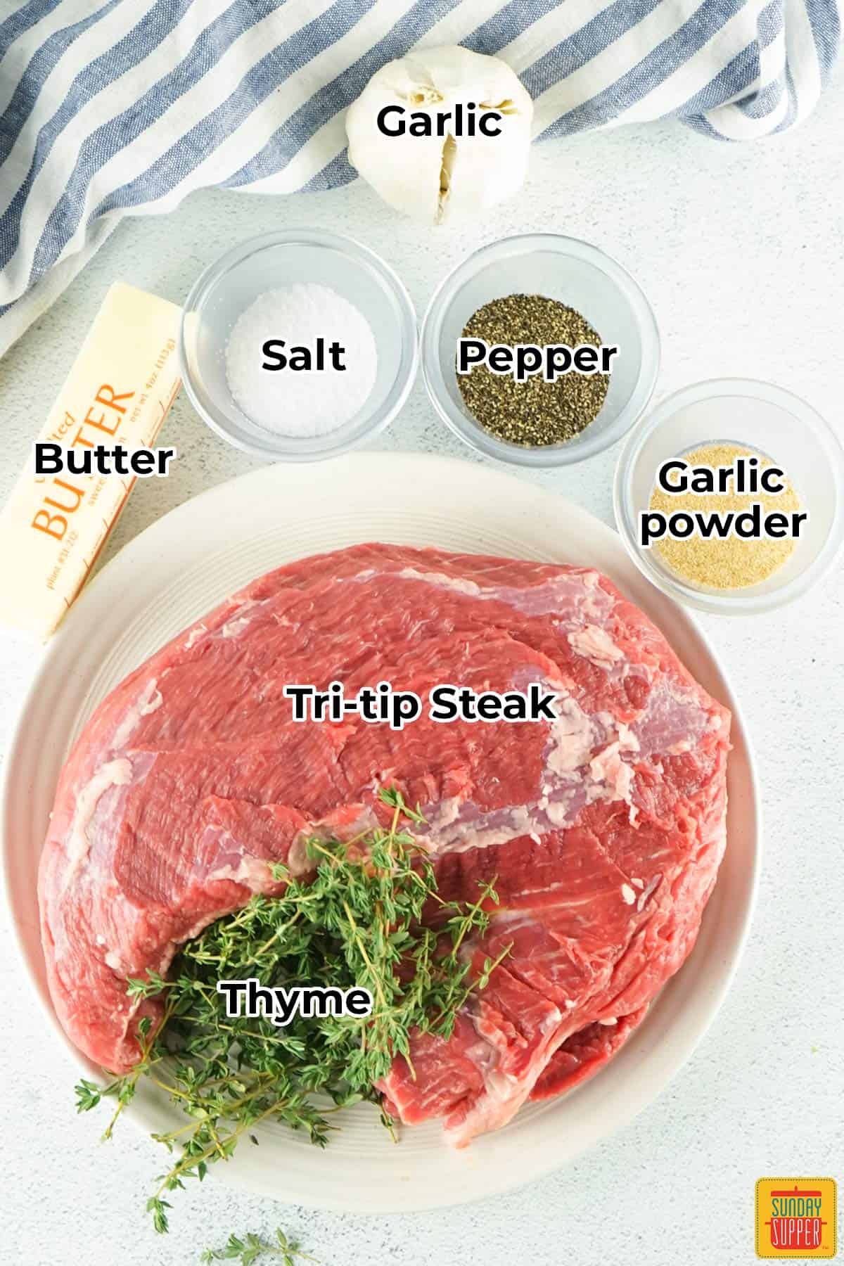 all of the ingredients for smoked tri tip in separate bowls with labels