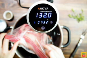 a closeup of a sous vide thermometer reading 132 degrees with 7 hours and 32 minutes on the timer