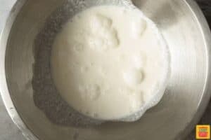whipped cream ingredients in a metal mixing bowl