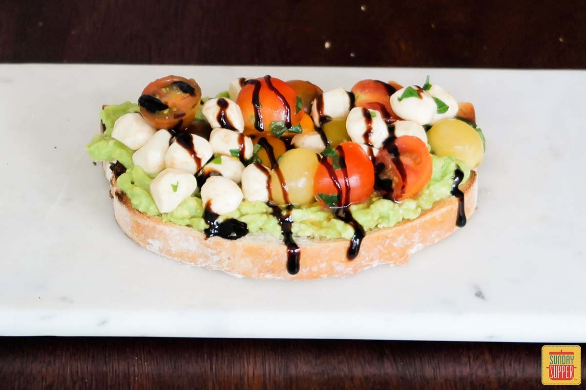 caprese toast with balsamic glaze drizzled over top