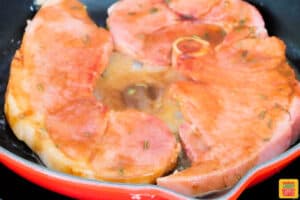 ham steaks on a pan coated in glaze