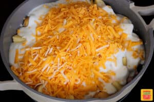 potatoes, bechamel sauce and cheese in a skillet