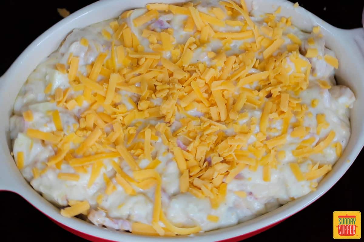 ham and potato casserole in a baking dish ready for the oven