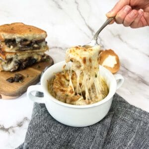 french onion soup with gooey cheese on top