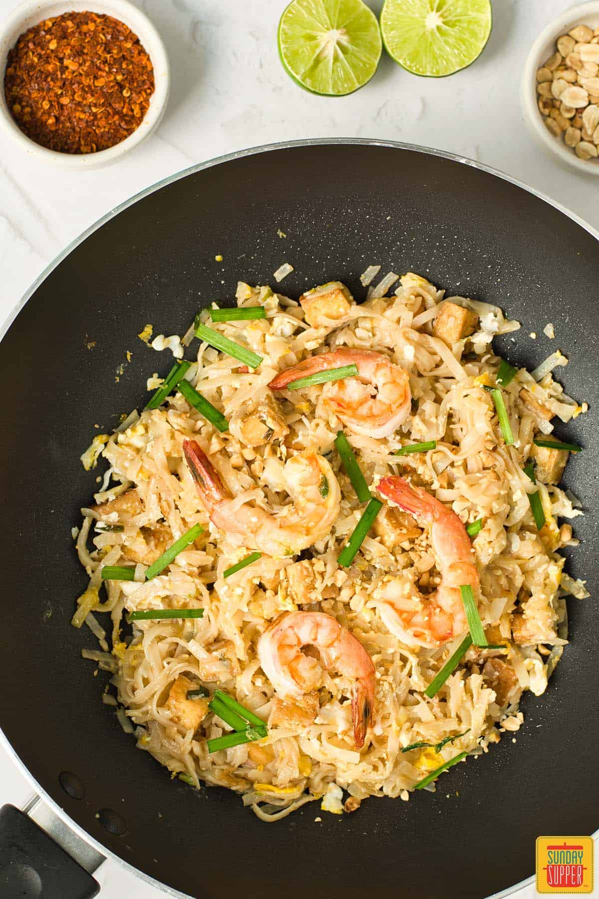 pad thai mixed in a wok ready to serve