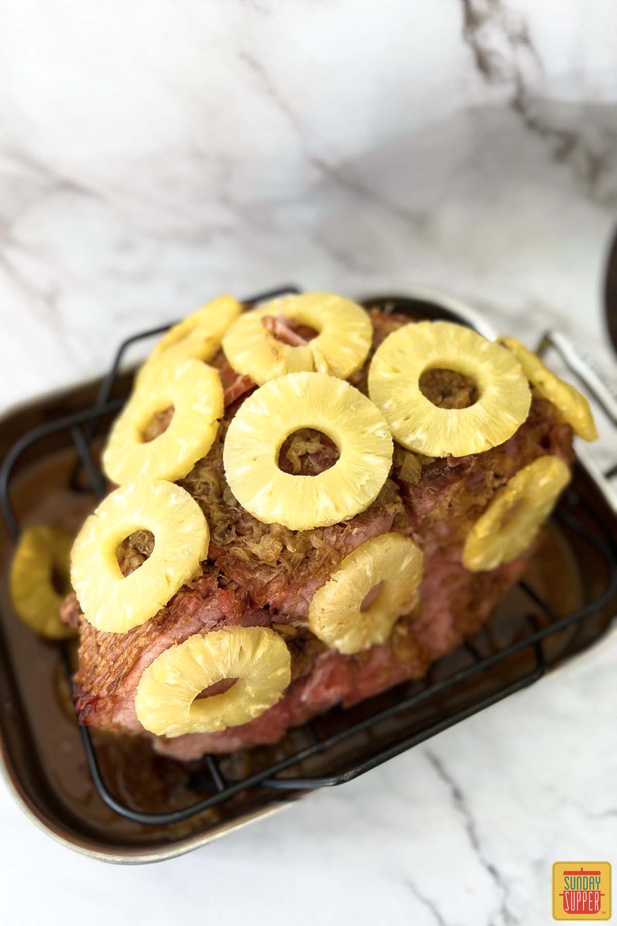pineapple rings over ham in a roasting tray