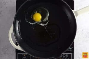 frying an egg in a pan