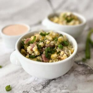 two bowls of fried rice with ham and a ramekin of yum yum sauce
