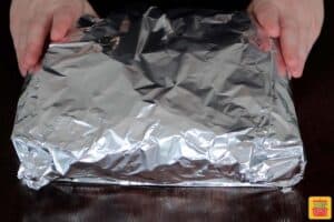 sliders wrapped in foil ready to bake