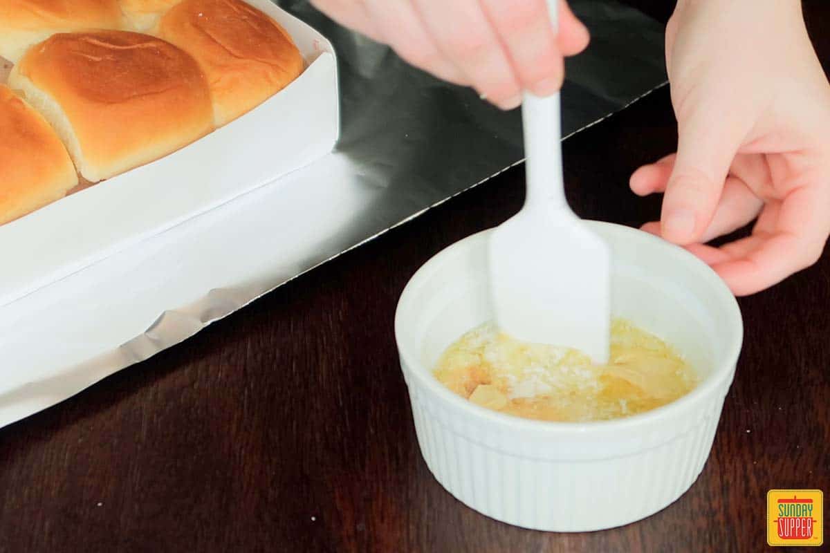 stirring melted butter in a ramekin
