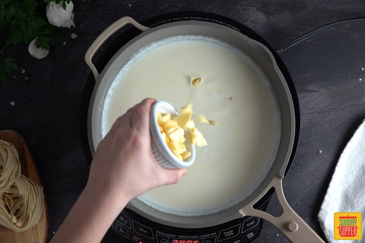 adding sliced American cheese in a skillet