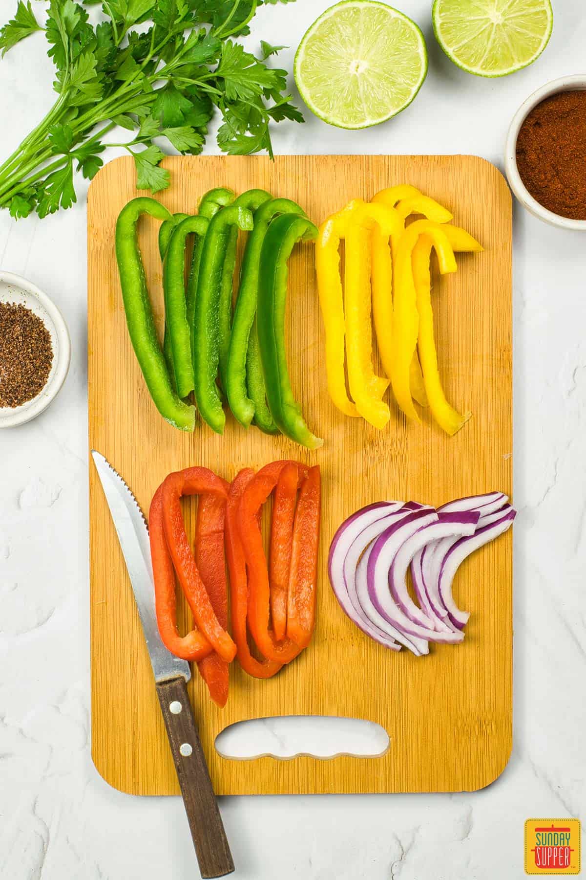 all of the peppers and onions sliced on a cutting board