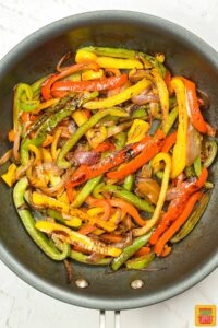 the peppers and onions browned in a pan