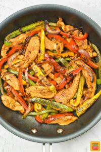 the mixed and completed chicken fajitas in a pan