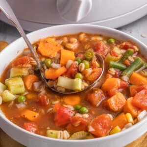 spoonful of crockpot vegetable soup in a bowl