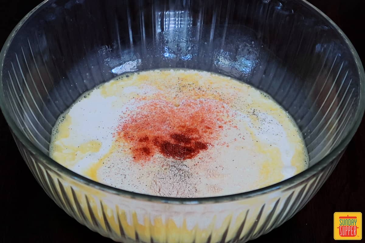 mixing eggs and seasoning in a bowl