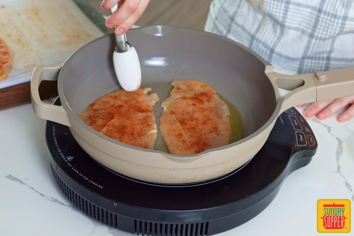 cooking chicken in a skillet
