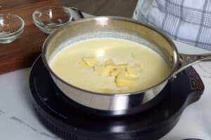 adding slices of white American cheese to a skillet